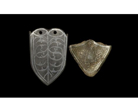 13th-15th century AD. A mixed group comprising: a tongue-shaped plaque with reserved scrolled tendrils on a niello field, pie