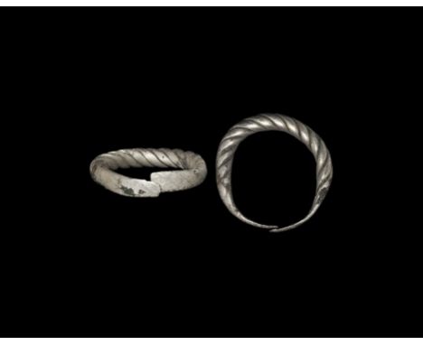 9th-12th century AD. A round-section penannular twisted silver hoop with flat terminals butt-jointed, Baltic workmanship. Cf.