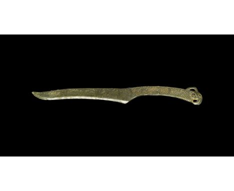 Ordos Culture, 6th-2nd century BC. A cast single-edged dagger with slightly recurved tip, the grip with incised hatched panel