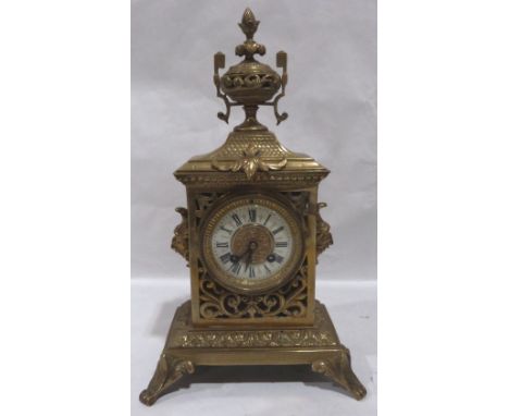 A French gilt brass mantle clock, the pierced cast case surmounted by an urn, the 8 day drum movement striking on a bell, 15'