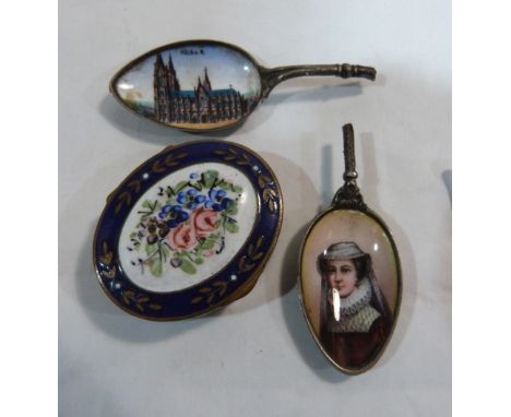 A 19th century brass and enamel patchbox, the lid with interior mirror and painted with a flower spray; together with two Ger