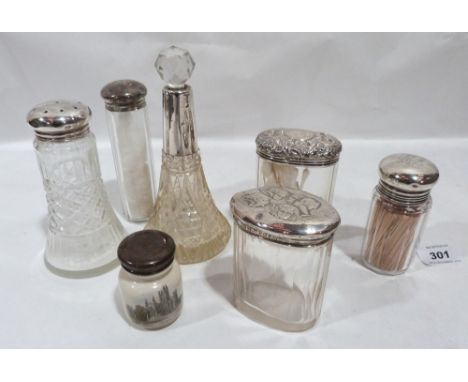 Four silver topped glass jars, a cut glass scent bottle, a cut glass sugar sifter and a silver topped ceramic jar. (7)