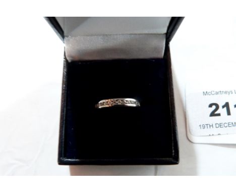 A channel set white stone ring. In white gold marked 375. Size K. 2.3g gross