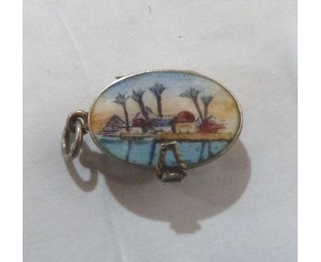 A silver gilt charm, in the form of the infant Moses in a basket, the lid with an enamel view of the Nile