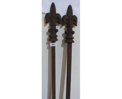 A pair of cast iron fleur-de-lys gate posts