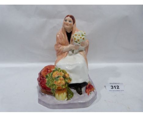 A Royal Worcester figure 'Dublin Flower Girl', modelled by Anne Acheson. 5½' high
