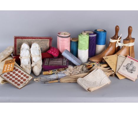 A mixed lot of haberdashery and accessories, including: lengths of ribbon, sewing patterns, a pair of 1920s white kid leather