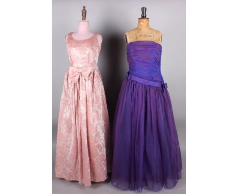 A 1930s ruby red silk velvet housecoat; with a 1950s County Clothes purple ball gown, a heavy brocade pink evening gown with 