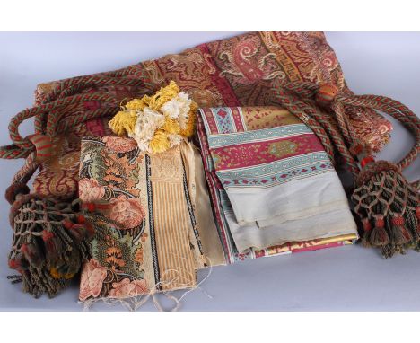 A bolt of upholstery weight fabric in a red and gold paisley pattern, a panel of glazed cotton fabric from Thailand, a pair o