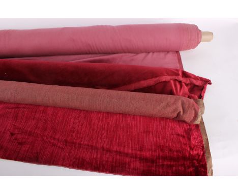 A roll of 1930s red silk velvet suitable for upholstery, with two further rolls of later (1970s) red velvet, two boxes of mid