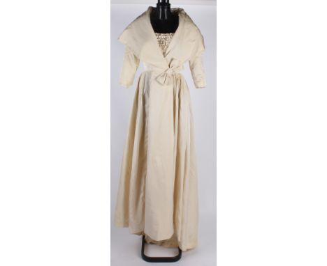 A late 1950s wedding dress designed by Mary Quant's cutter, worn in August 1960, the ivory satin full-length dress with a lar