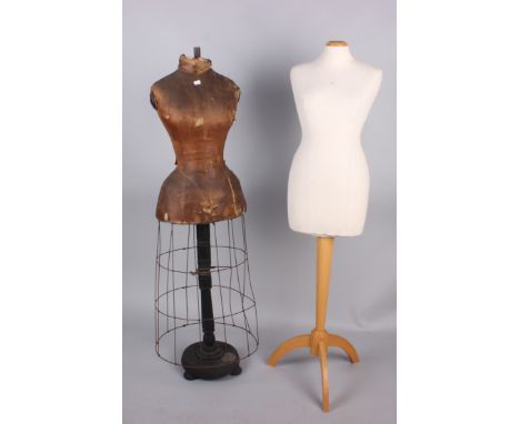 A 19th century mannequin, with linen-covered torso and metal cage frame skirt; and a modern mannequin on a wooden stand, (2).