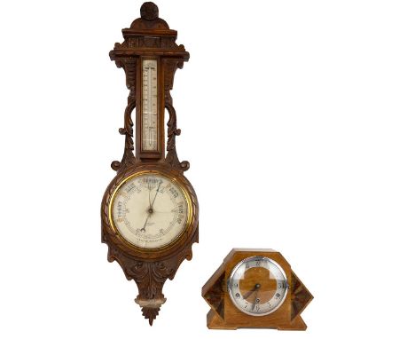 Art Deco three train mantle clock with inlaid sunburst; and a carved oak cased aneroid barometer by Barry &amp; Sons, Cardiff