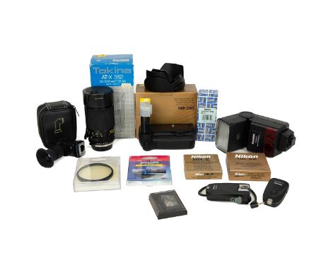 A collection of camera accessories to include Tokina AT-X 352 lens, Nikon battery pack and other items.