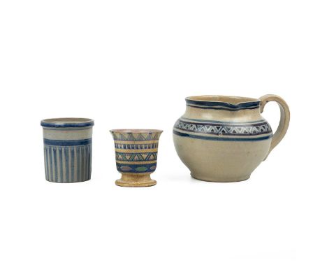 Carter Stabler &amp; Adams - three pieces of 1920's Poole Pottery comprising a large, low pitcher; a brush pot; and a short s