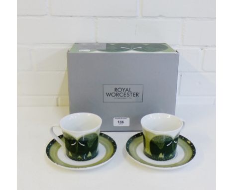 A boxed Royal Worcester tea cup and saucer set in the 'Fold' pattern designed by Govinder Nazram, comprising two cups and two