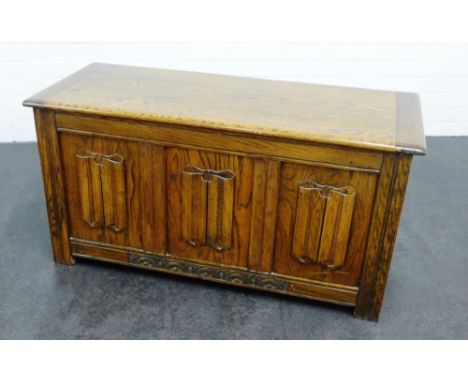 An oak trunk with panelled front, the lift up top opening to reveal plain interior, 54 x 106cm 
