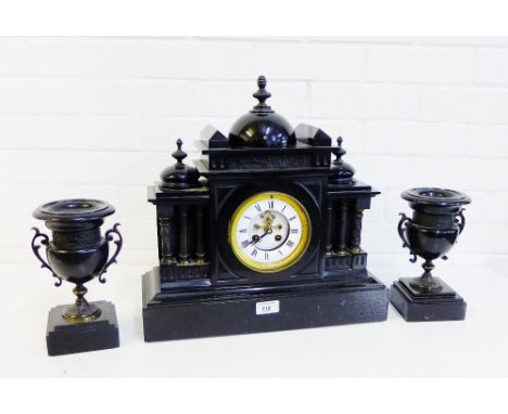 A black slate clock garniture of architectural design, (3) 