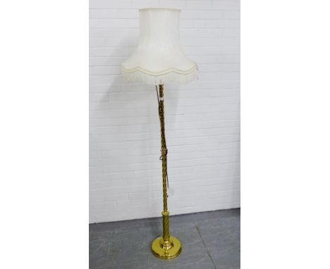 A brass standard lamp and shade