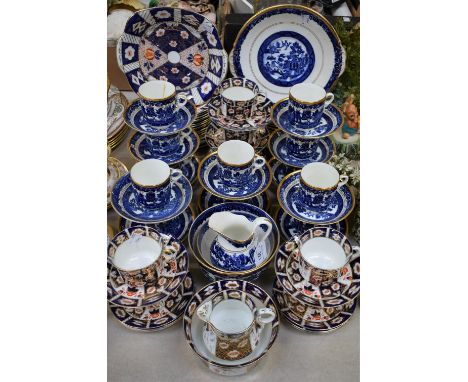 A Victorian Staffordshire Willow pattern part tea service comprising bread and butter plates, side plates, slop bowl, sugar b