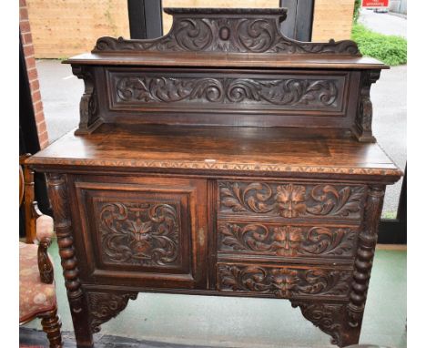 A Victorian oak sideboard, shelved half gallery crested by scrolling acanthus, the projecting base with three short drawers n