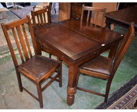 An oak draw-leaf dining table and four chairs (5)