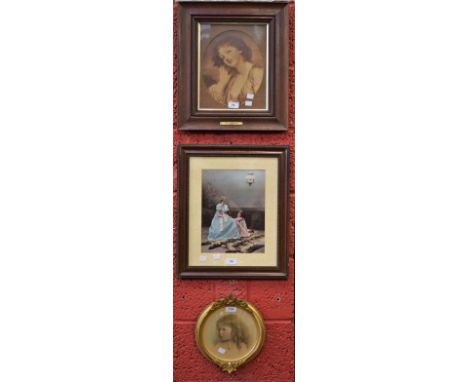 A circular gesso picture frame, moulded crest with vine leaves and berries, reeded edge, with a portrait photograph of a youn
