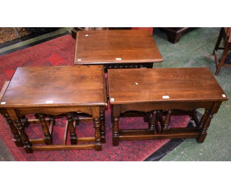 An oak nest of three tables, side loading, the largest 72.5cm wide; another similar; an oak low occasional table, foliate sup