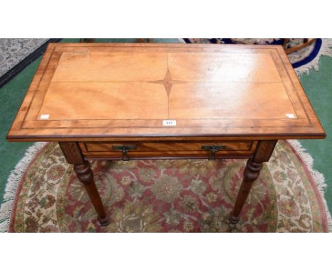 An Arts and Crafts side/writing table, oversailing rectangular top centrally inlaid with a four pointed isotoxal star above a