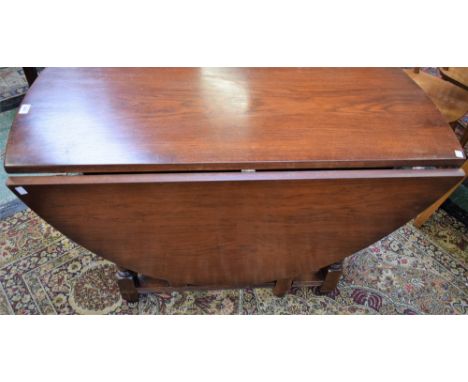 An Old Charm oak gateleg dining table, elliptical top with fall leaves, turned supports, opening to 152.5cm