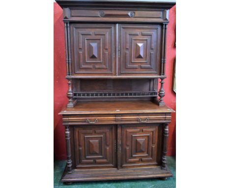 A Victorian oak buffet/sideboard, outswept cornice above a pair of panel doors applied with geometric mouldings enclosing two