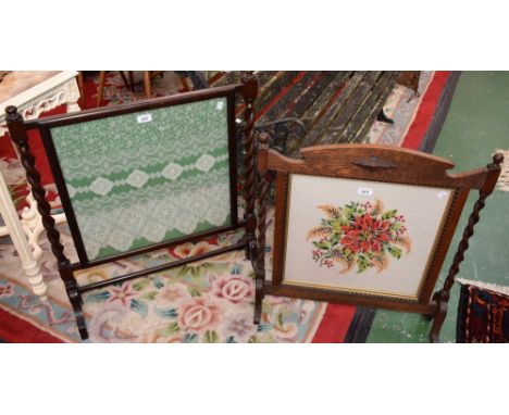 An early 20th century fire screen, barley twist columns, cream lace on green ground; another, shaped crest, barley twist colu