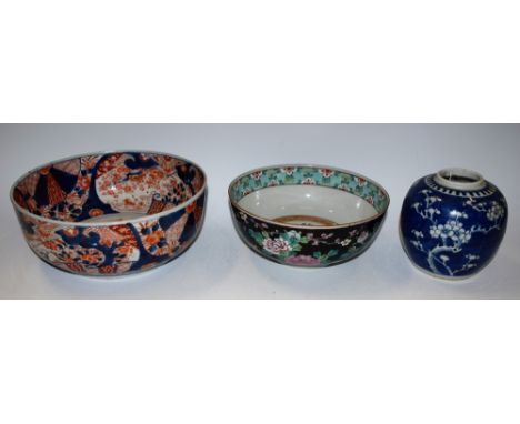 A Japanese Imari bowl, 25cm diameter; a Chinese famille noir bowl, 21cm diameter; a Chinese blue and white ginger jar (3)