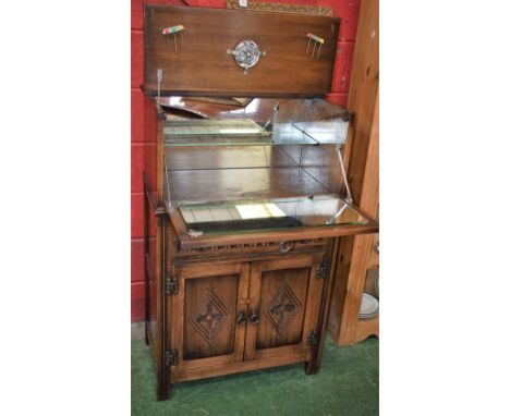 An Old Charm style oak drinks/side cabinet, rectangular hinged top opening in conjunction with the linen fold fall front door