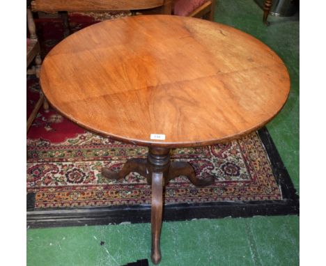 A George III mahogany tripod occasional table, circular tilting one piece top, turned pillar, cabriole legs, pad feet, 71cm h