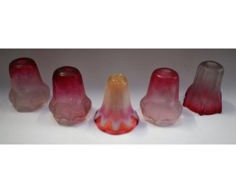 A set of three 19th century cranberry glass lamp shades, frosted with bows and swags with flowers; another Art Nouveau shade 