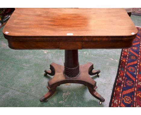 A Regency mahogany D-shaped card table, folding top enclosing an inset baize lined playing surface, above a deep frieze centr