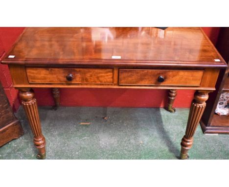 A Victorian design side table, oversailing rectangular top above a pair of frieze drawers, reeded tapered cylindrical legs, b