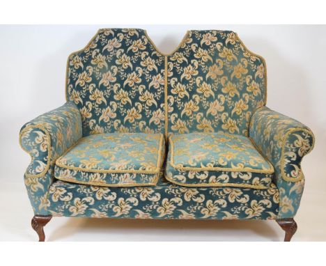 A Queen Anne style sofa with double arched back and two loose cushions, on cabriole legs, shell carved to the knee, 155cm wid