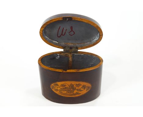 A late 18th century oval mahogany tea caddy, inlaid with baskets of flowers, 12cm high x 15cm wide