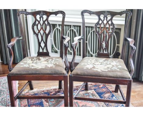 A pair of George III mahogany elbow chairs with pierced inter-linked splats, and drop in tapestry seats, on square legs