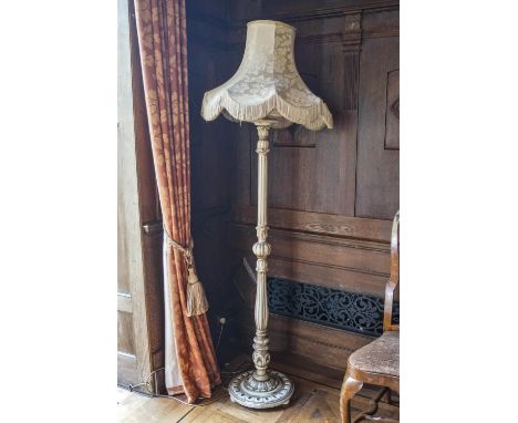 A cream standard lamp on round base with bun feet, 187cm high