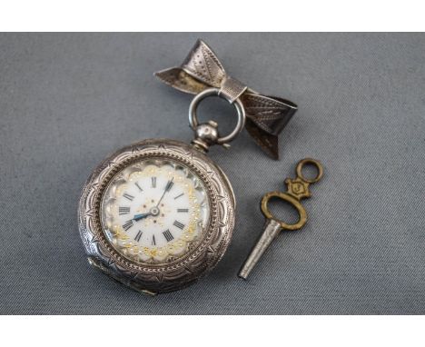 A silver (0.935) open face pocket watch with white ceramic dial having roman numerals and gold embellishments. Key wound move