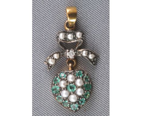 A yellow and white metal heart and bow design pendant set with emeralds, round cut diamonds and seed pearls. No hallmark - ac