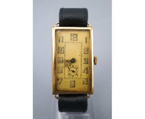 A rolled gold wristwatch. Rectangular hinged case. Manual wind (unsigned) movement. Black leather strap with pin buckle. 31.2
