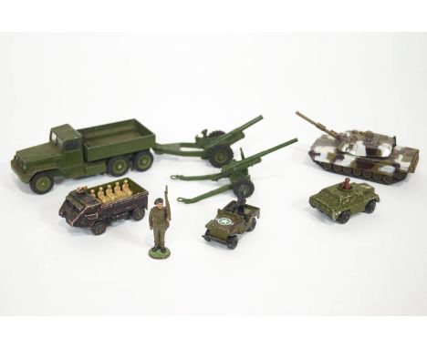 A group of Corgi, Dinky and other cast metal toys, all Army, to include a flatbed truck, tanks and field guns