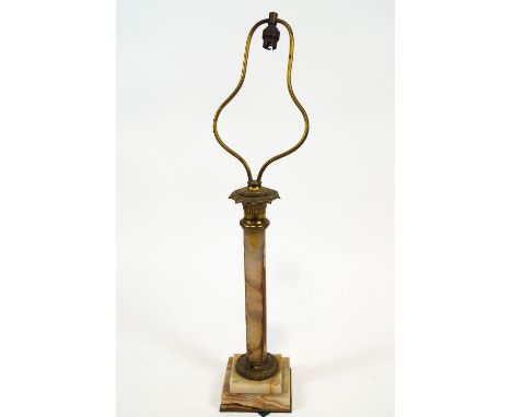 An onyx and brass columnar table lamp with a foliate cast capital raised on a tiered square base, 72cm high