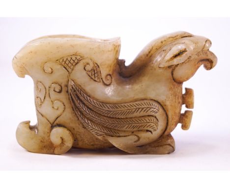 An Asian carved jade Libation cup in the form of a resting griffin, 13cm wide