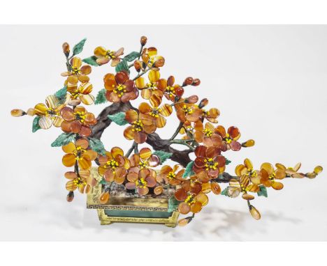 A Chinese banded orange and green agate model of a flowering Bonsai tree, set on a composite trunk in a brass hardstone and e