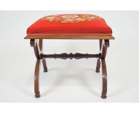 A Victorian footstool, with tapestry seat on mahogany X frame linked by a turned stretcher